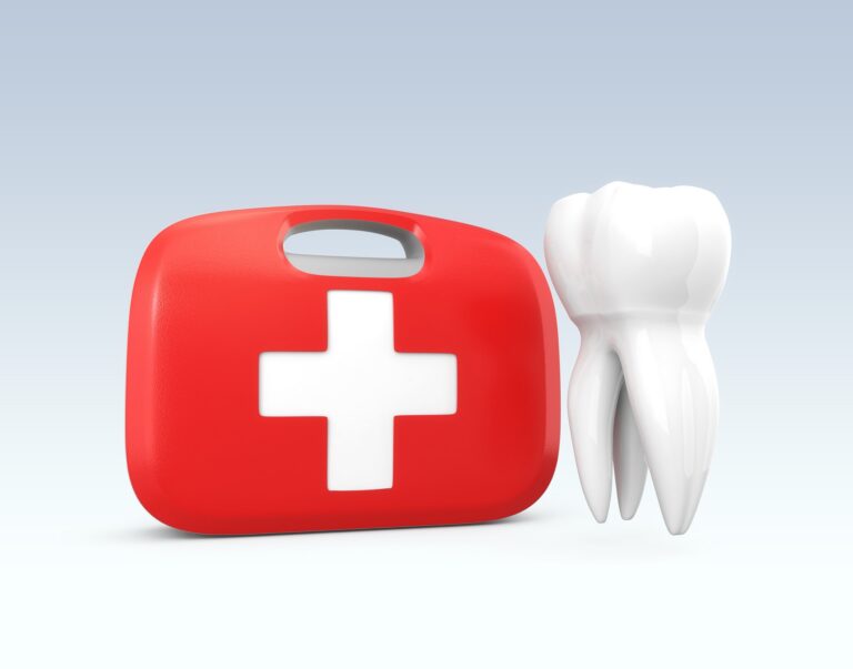 Red emergency medical kit with a white cross symbol placed beside a tooth model. The image represents emergency dentistry and urgent dental care services.