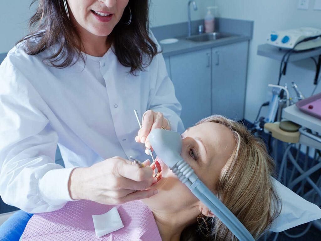 picture of woman getting sedation in dental chair
