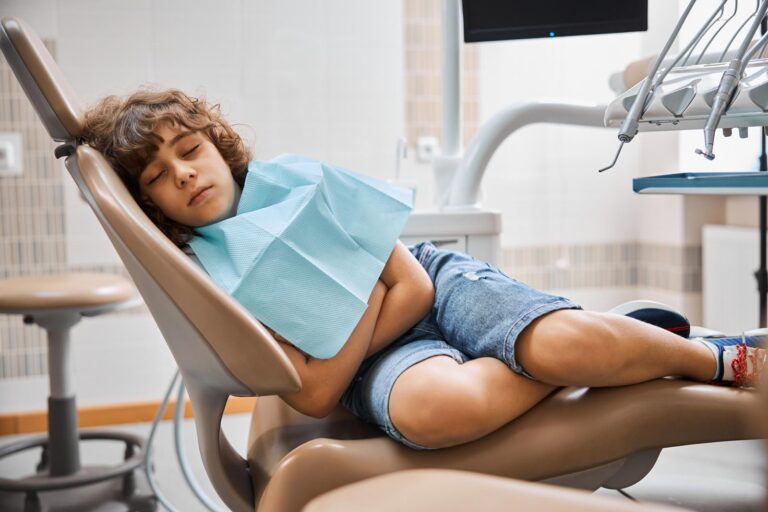 Child resting comfortably in a dental chair during oral sedation at Healthy Smiles Family Dentistry. The relaxed environment helps ensure a stress free and comfortable dental experience for young patients.